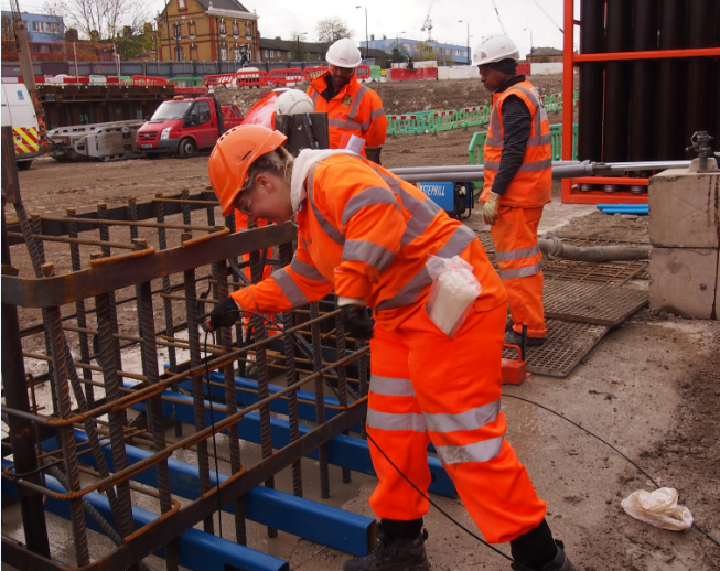 CSIC trained Cementation Skanska technician Maria Scott installing fibre optic sensor cable on a reinforced cage of a diaphragm wall at Battersea Station. Image Courtesy of Cementation Skanska. CSIC trained Cementation Skanska technician Maria Scott installing fibre optic sensor cable on a reinforced cage of a diaphragm wall at Battersea Station. Image courtesy of Cementation Skanska.